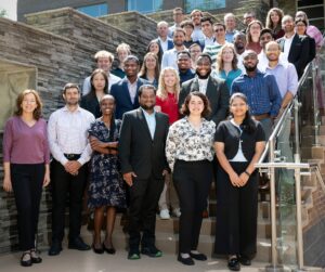 Graduate students gathered together on campus for a group photo.